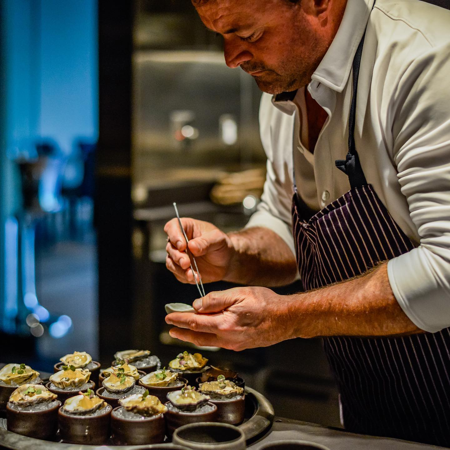 Chef Douglas Keane preparing oysters
